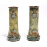 A pair of Royal Doulton stoneware vases of round tapered form & olive-green ground, decorated with