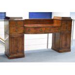 A regency mahogany pedestal sideboard, the centre fitted two drawers, a cellarette drawer above a