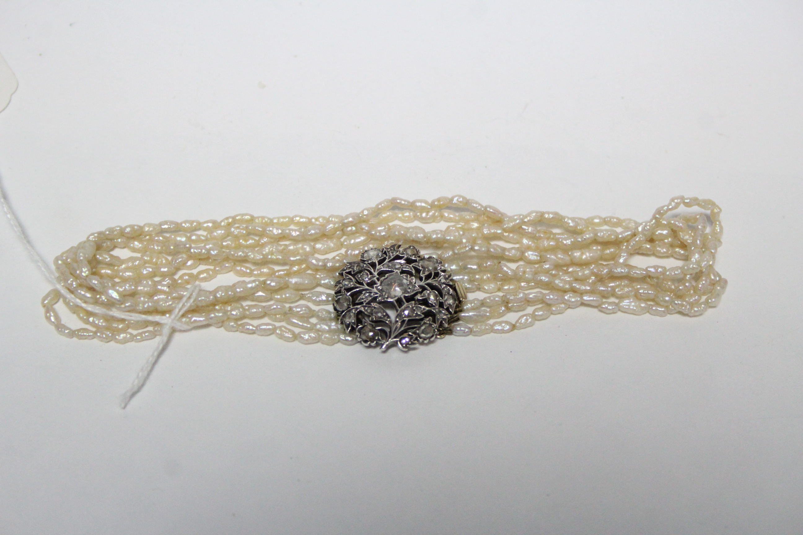 A six-strand choker of small blister pearls, with large open-work circular floral clasp set numerous - Image 3 of 3