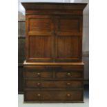 An early 19th century provincial oak & mahogany linen press, the upper part fitted three shelves