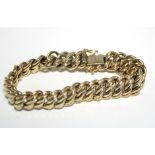 A 9ct. gold flexible bracelet of inter-woven & engraved curb links; 7¼” long. (22.7gm).