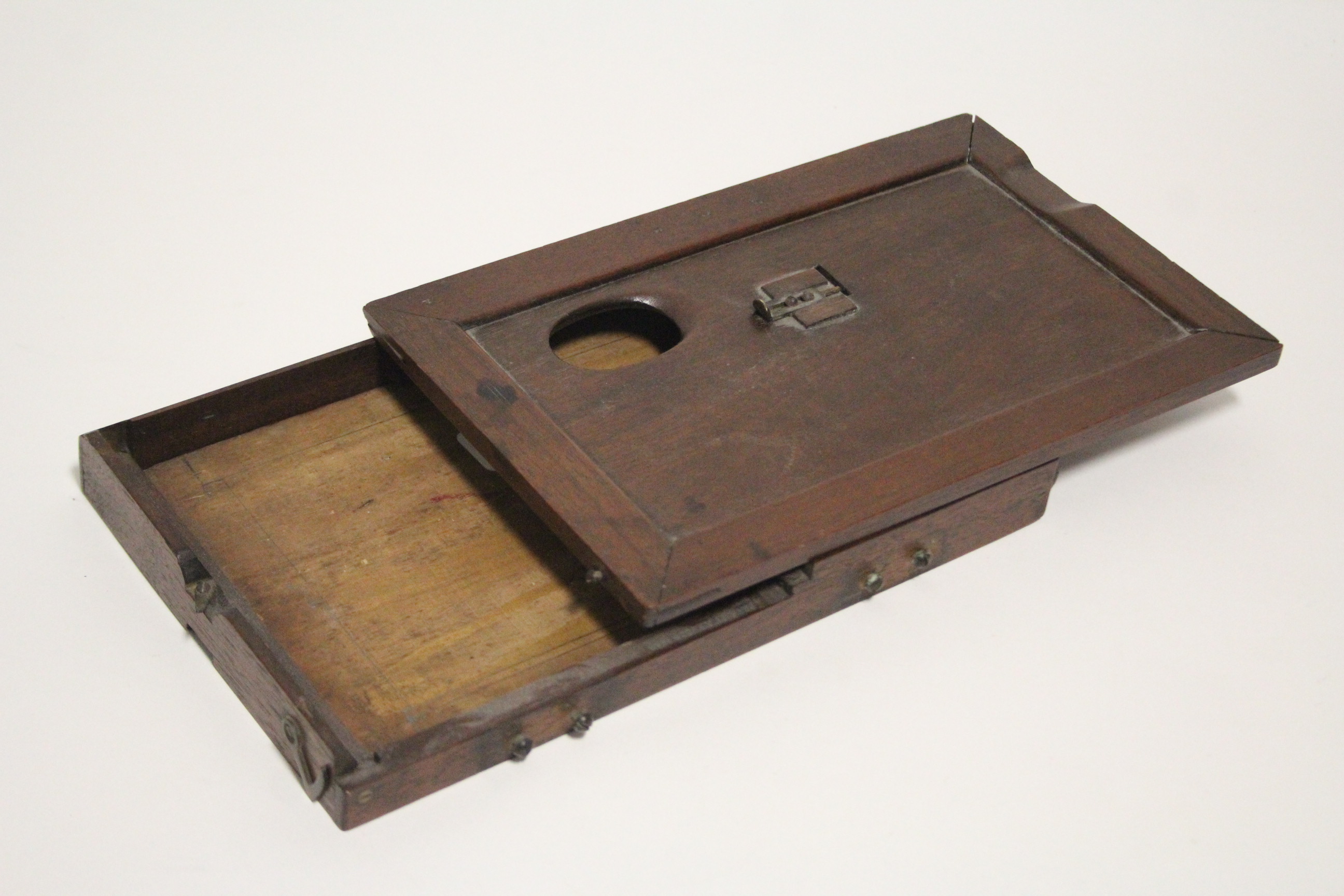 A late 19th/early 20th century mahogany portable artist’s box with adjustable rest & removable