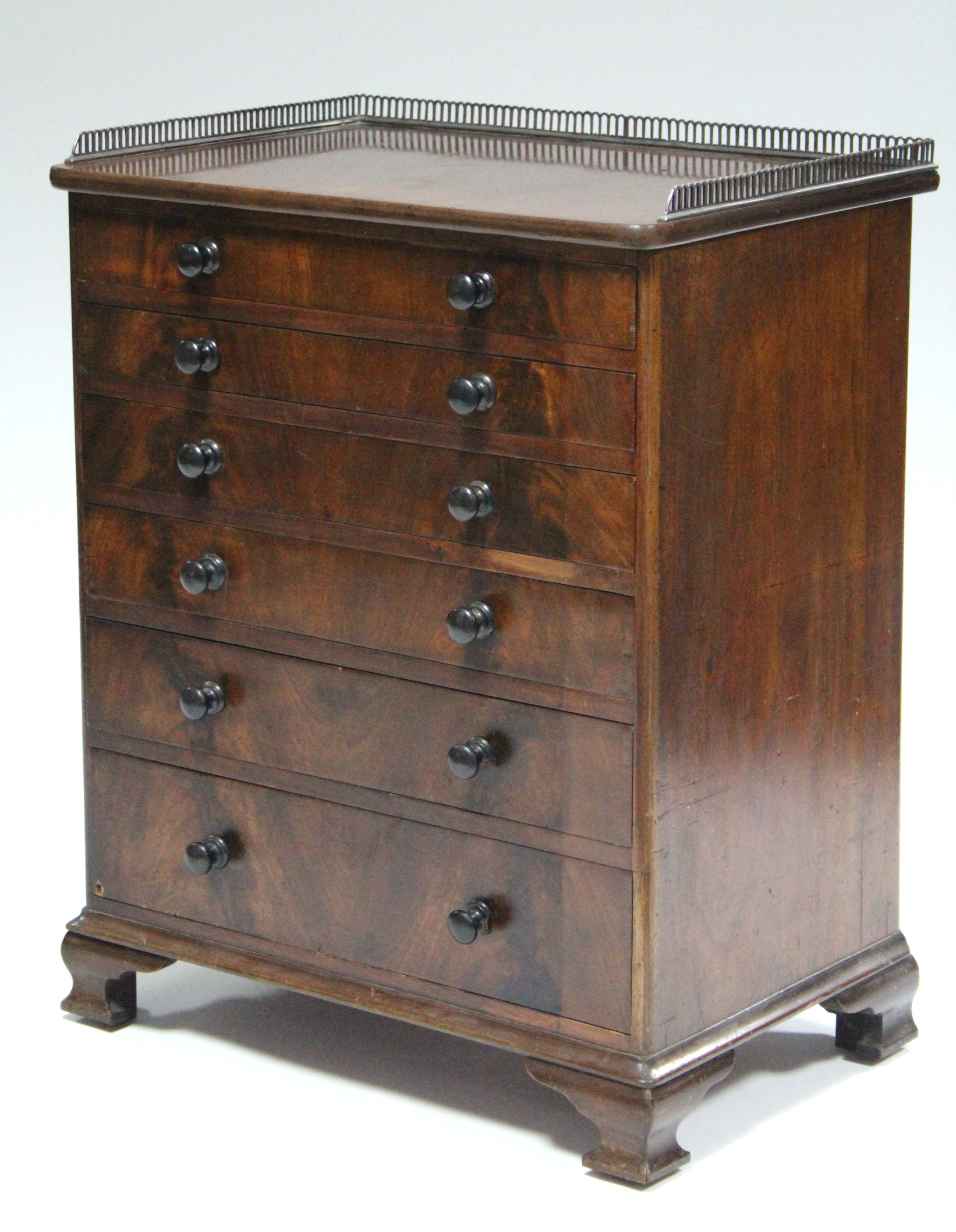 A mid-Victorian mahogany chest of six long graduated drawers with turned knob handles, the top