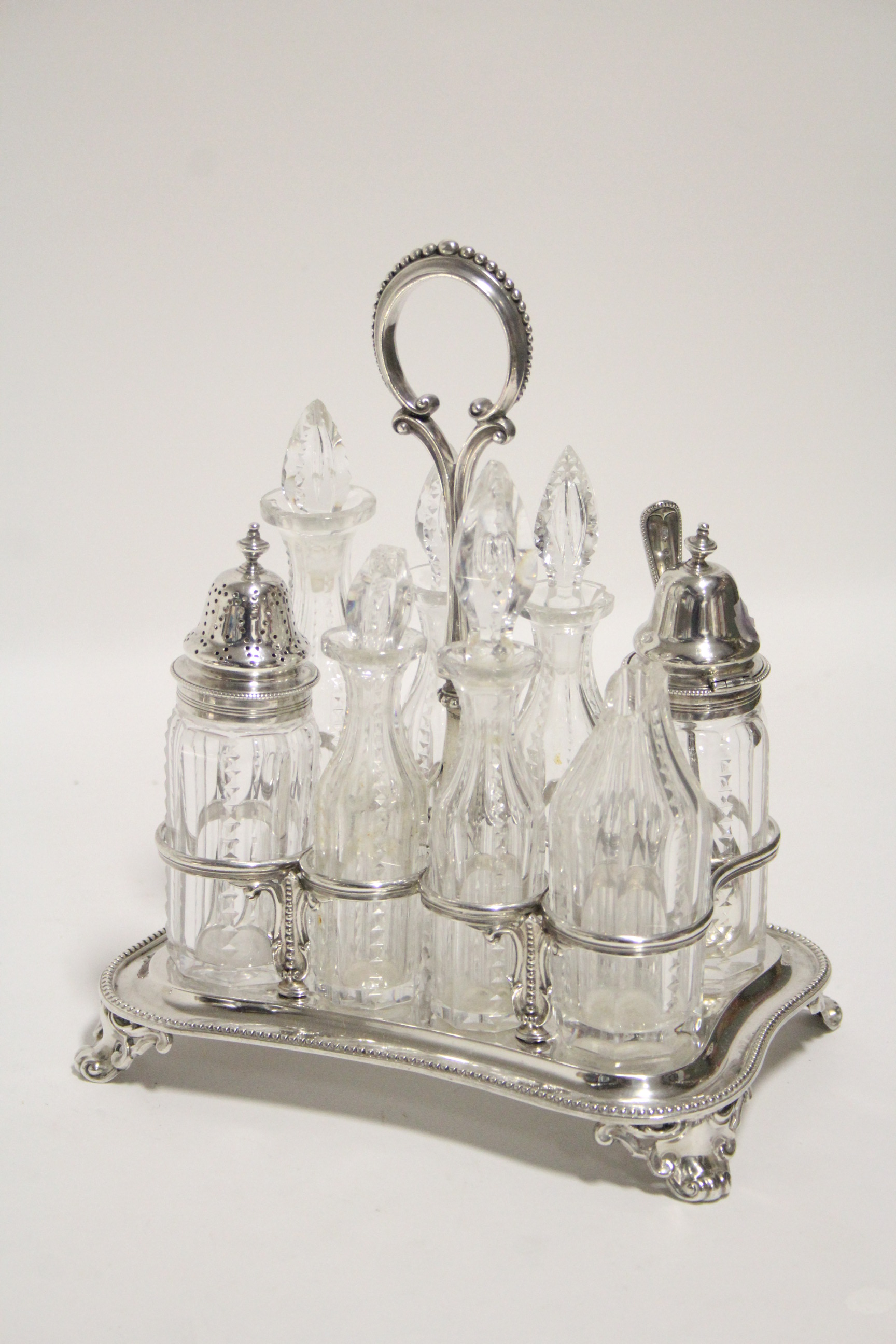 A Victorian rectangular eight-division cruet stand with centre ring handle, beaded rim, & on four - Image 2 of 2