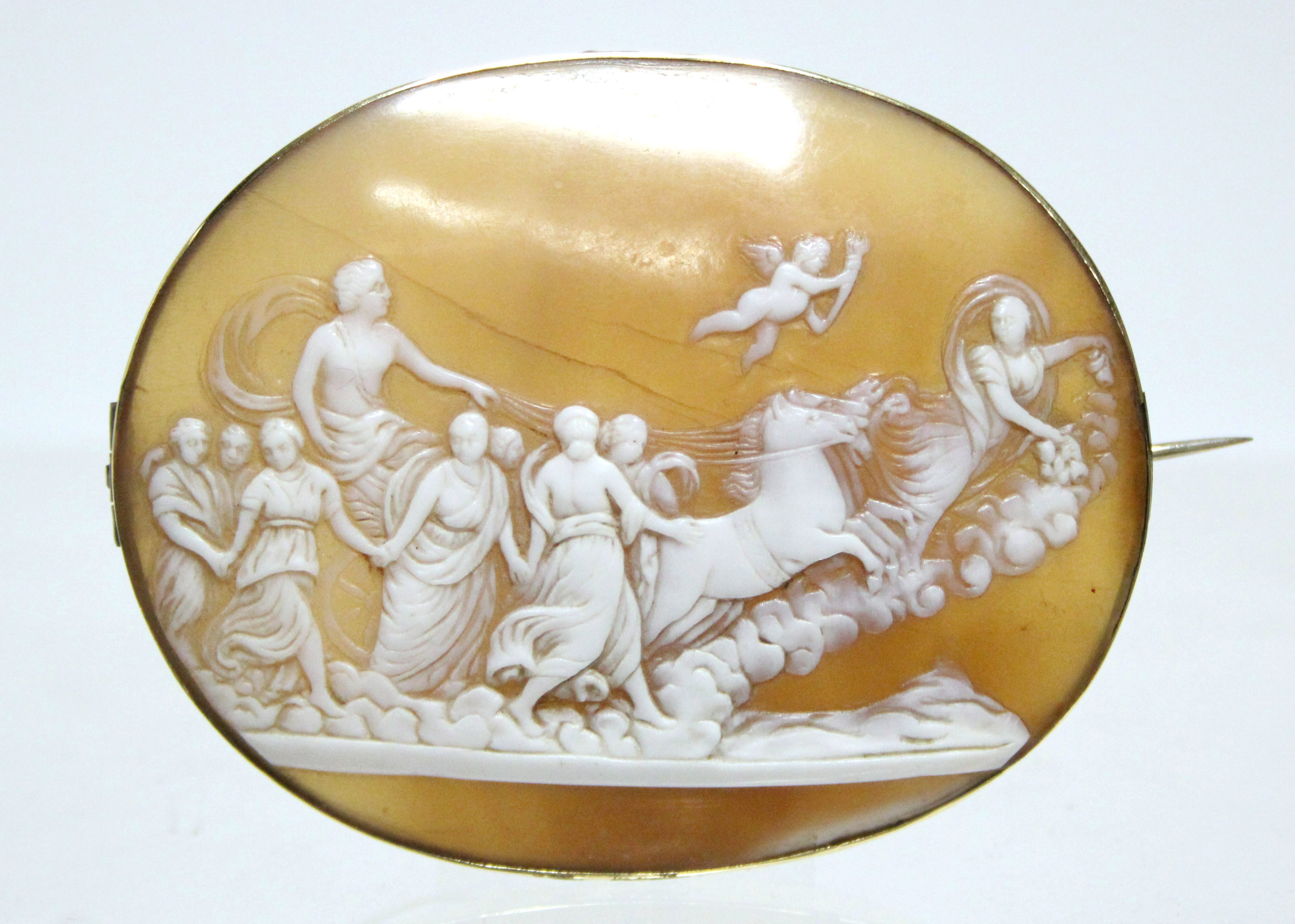 A 19th century carved shell oval cameo brooch depicting Apollo & Aurora after the painting by