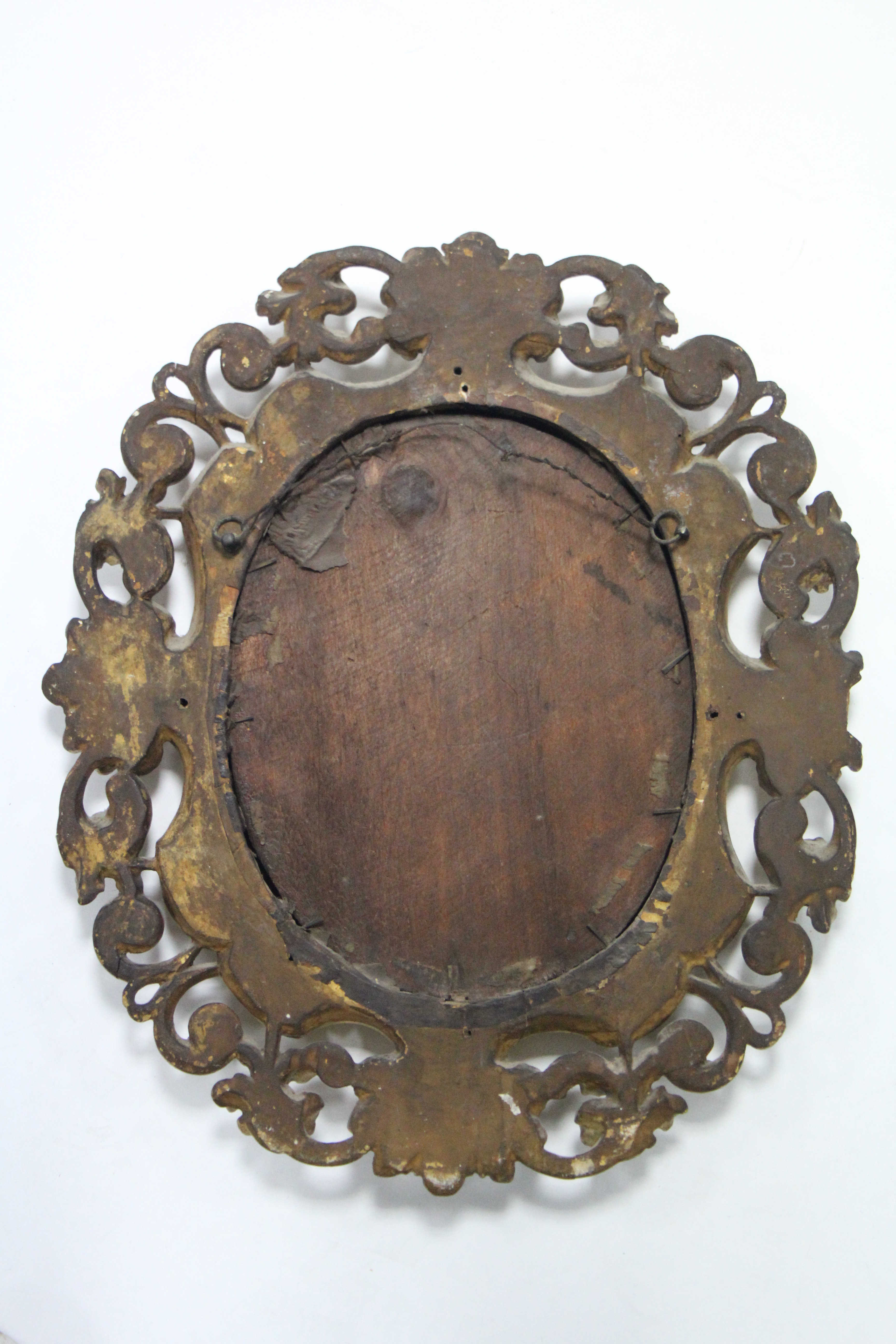 An 18th century Florentine carved giltwood frame oval wall mirror; 17½” x 15½”. - Image 2 of 2