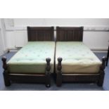 A pair of 17th century-style oak single bedsteads with panelled head & foot boards, each with
