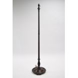 A late Victorian carved mahogany standard lamp, the baluster turned & fluted column on circular