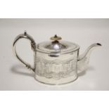 A George III oval straight-sided teapot with repoussé Chinoiserie decoration; London 1794, by