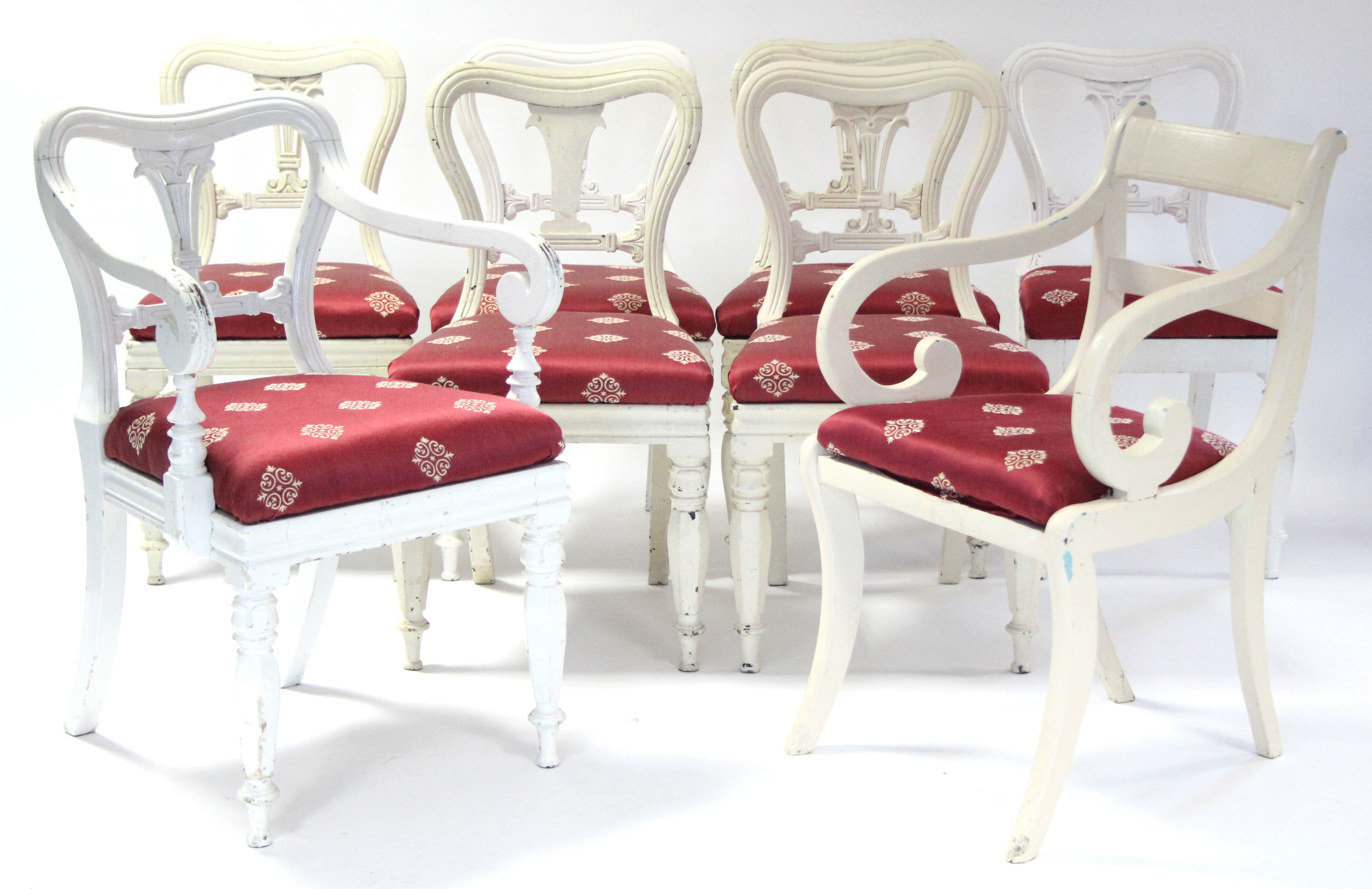 A matched set of eight early Victorian dining chairs with padded drop-in seats upholstered crimson