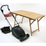 An Atco “Regent 14” electric lawnmower with grass box, WO, and a teak fold-away table, 54½” x 27½”.