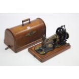 11. A Singer hand sewing machine with walnut carrying case.