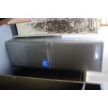 An Indesit A-class upright fridge-freezer in silvered-finish case, w.o.