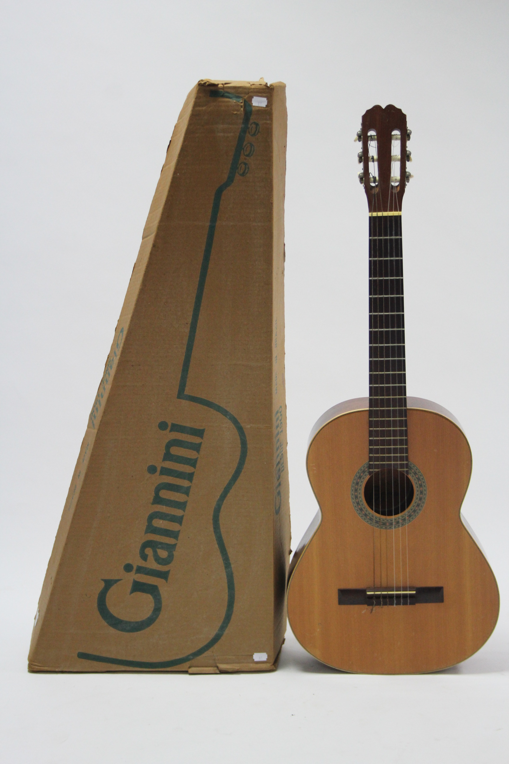 A Spanish six-string acoustic guitar, boxed.