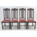 A set of four 1930's carved rail back dining chairs with padded drop-in seats, & on barley-twist