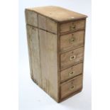 A pine standing upright sloping-front office chest fitted five long drawers with brass flush handles