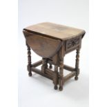 A similar oval gate-leg occasional table fitted end drawer & on turned legs & turned feet with