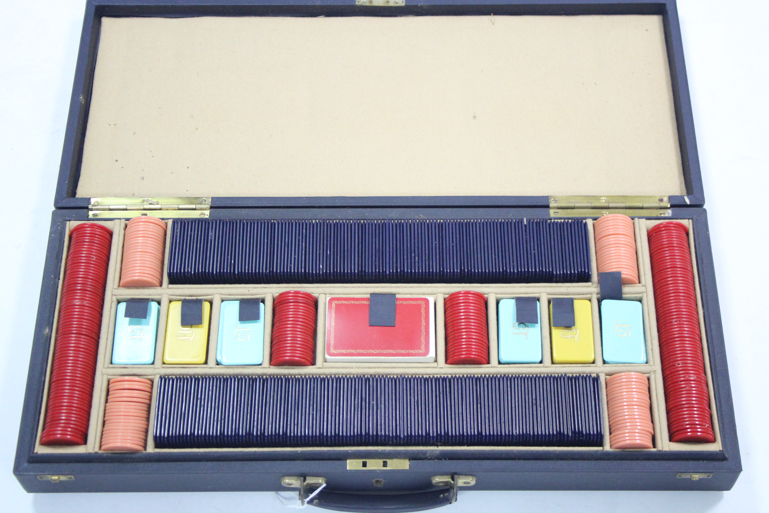 Various gaming counters & two sets of playing cards contained in a blue fibre-covered case.