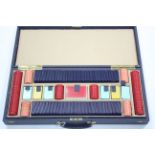 Various gaming counters & two sets of playing cards contained in a blue fibre-covered case.