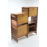 A STAPLES TEAK "LADDERAX" LOW WALL UNIT, fitted with an arrangement of cupboards &open shelves,