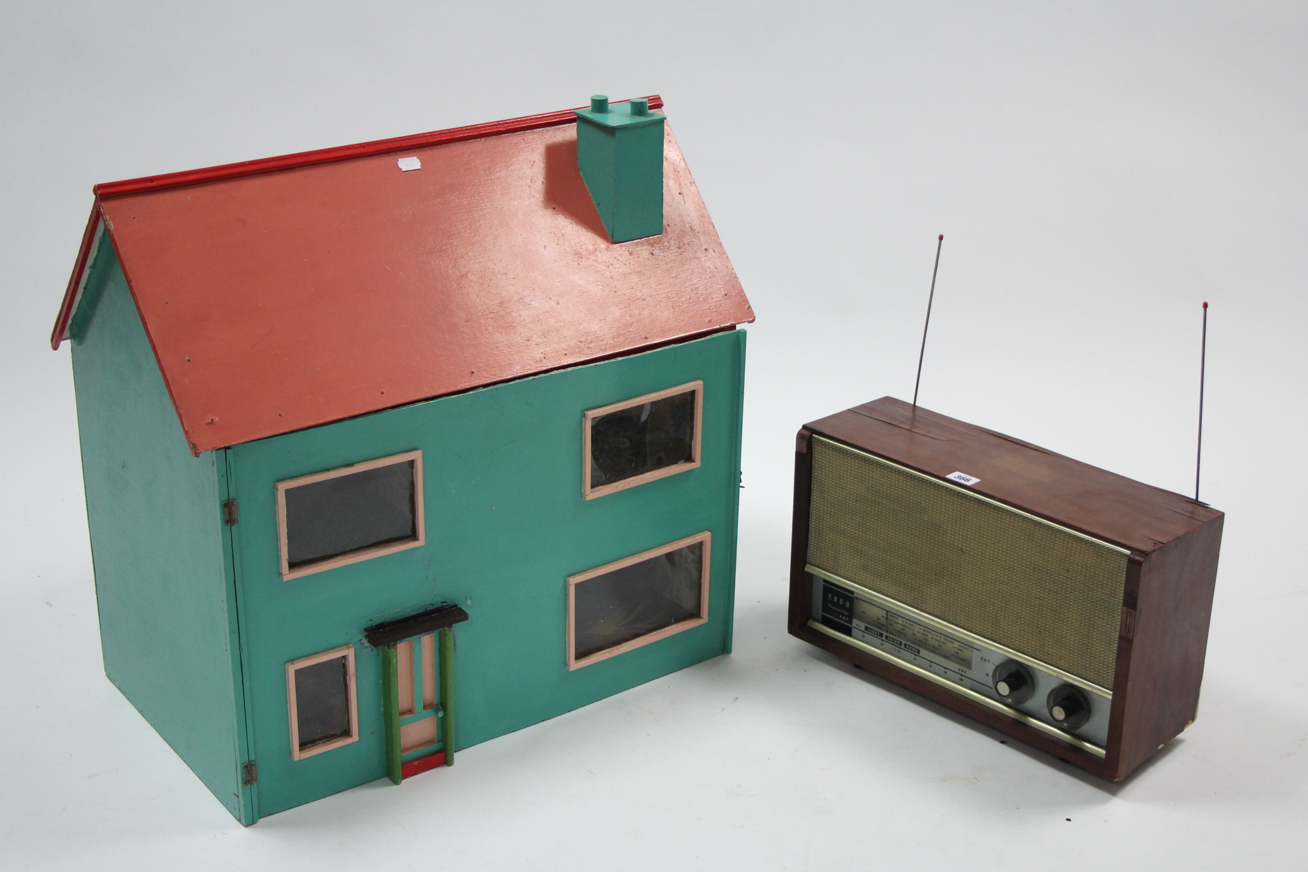 An Ekco transistor radio in mahogany-finish case; & a painted wooden two-storey doll’s house with