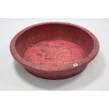 A crimson stained wooden large circular bowl, 29" diam.