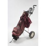 A set of thirteen MacGregors “Battlestick” left-handed golf clubs with golf club bag & trolley.