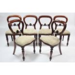 A set of six Victorian-style mahogany balloon-back dining chairs with carved & pierced centre rails,