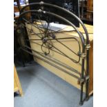 A continental-style wrought-metal 4' 6" bedstead, complete with side rails.