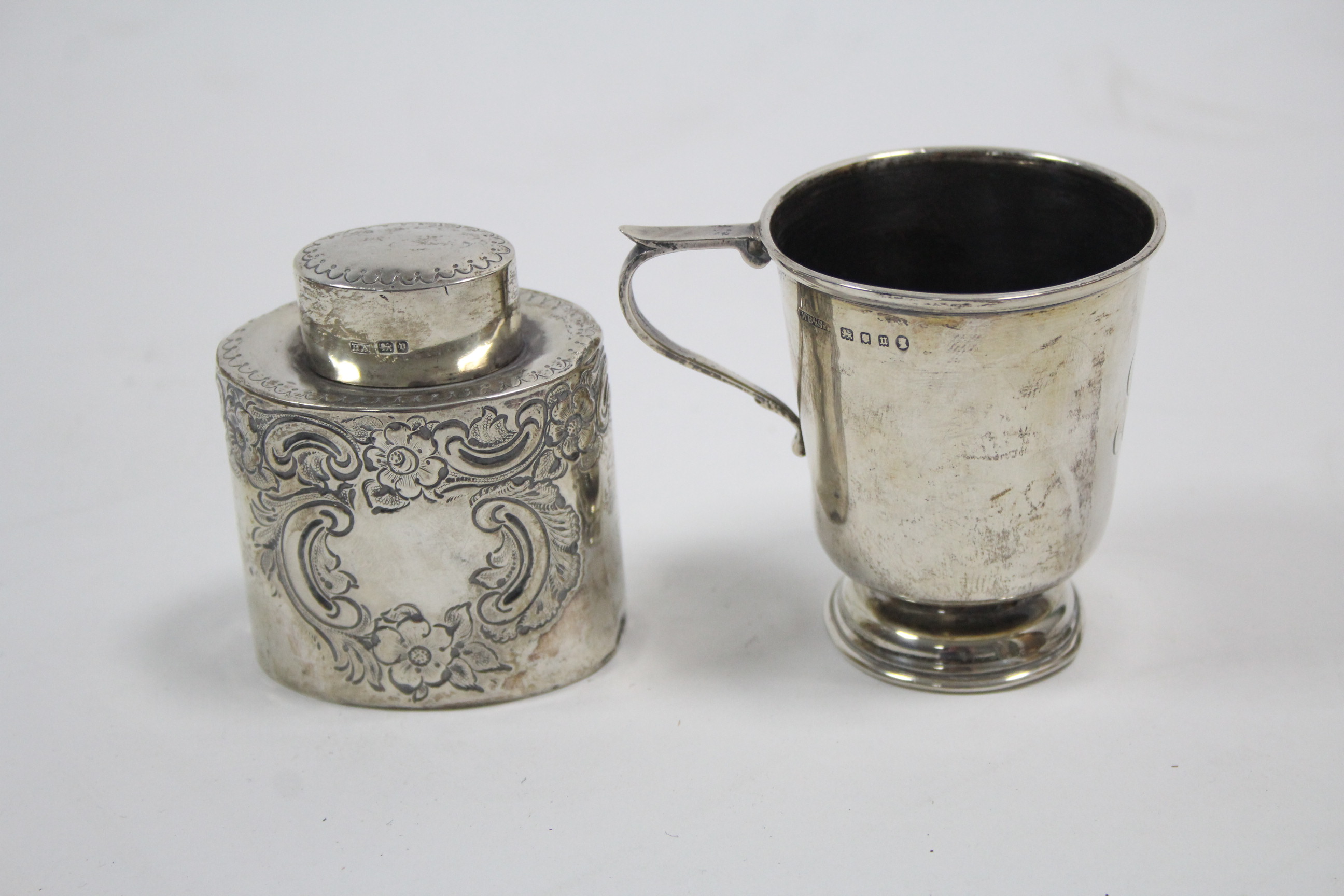 An Edwardian small silver oval teapoy with raised scroll & floral design, 2¾" high, Sheffield