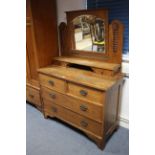 A late 19th/early 20th century carved oak dressing chest with rectangular swing mirror to the