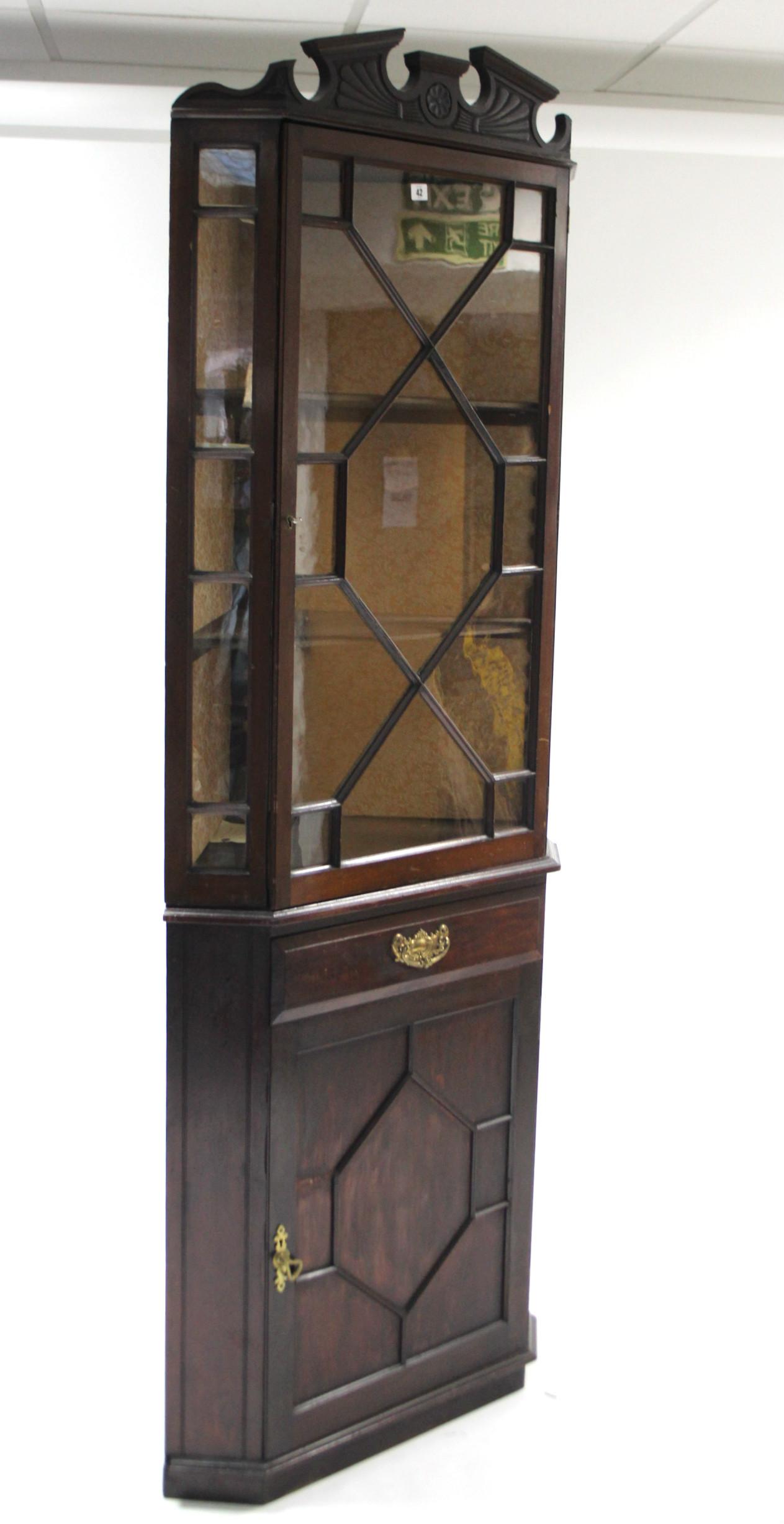 A late 19th/early 20th century tall mahogany standing corner cabinet, the upper part fitted two