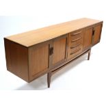 A G-PLAN TEAK SIDEBOARD, fitted four long graduated drawers to centre flanked by cupboard to