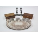 An engraved silver plated oval two-handled tea tray, 23¾” x 16½”; a pair of pewter candlesticks,