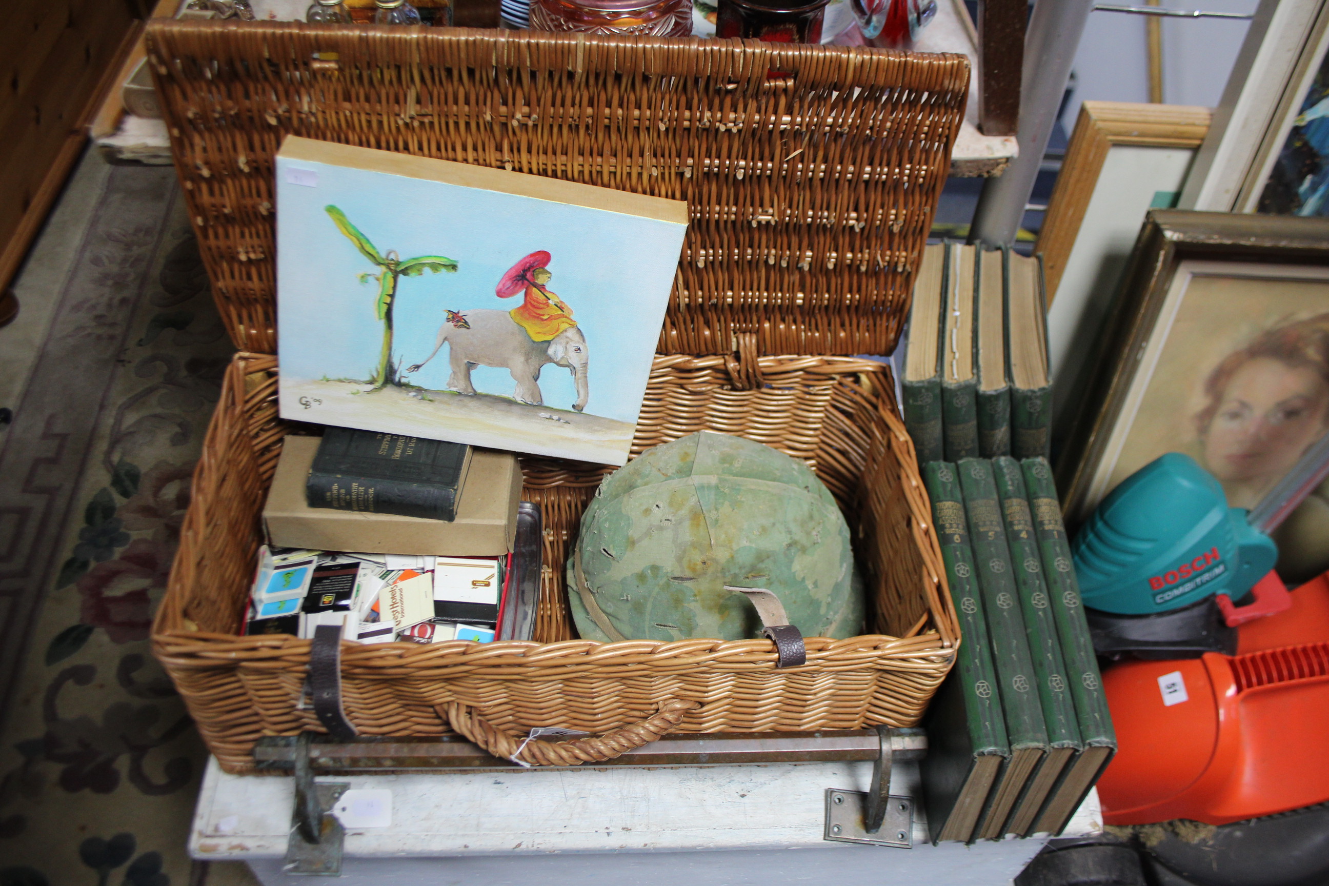 A wicker hamper (lacking contents), 23" wide; together with four decorative pictures, various books,