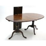 A ditto twin-pedestal extending dining table with oval top, centre leaf, & on vase-turned end