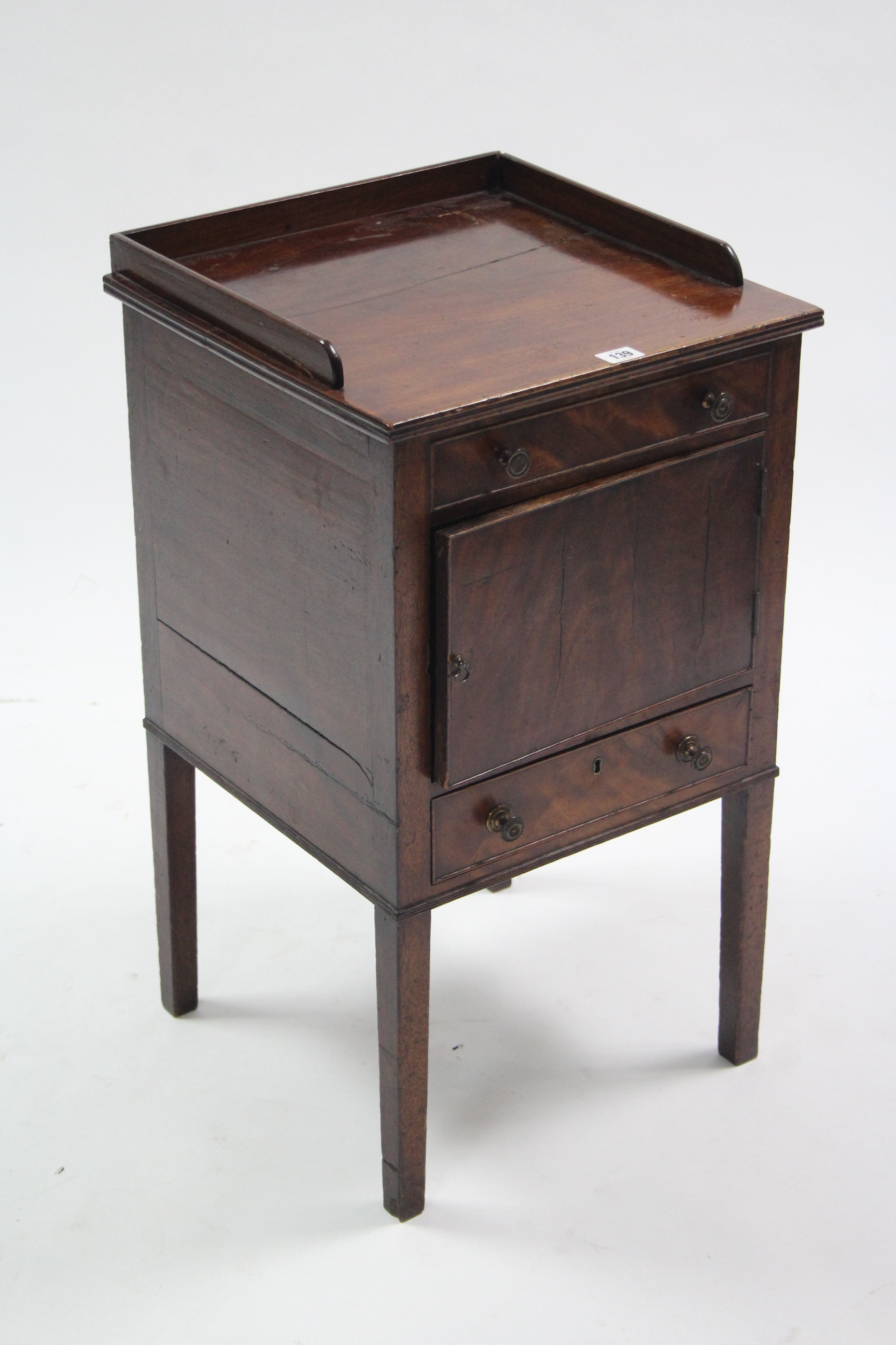 A late 19th/early 20th century mahogany tray-top washstand with cupboard to centre enclosed by panel