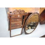 A carved oak frame oval wall mirror inset bevelled plate, 24” x 35”; & a similar rectangular wall