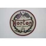 A reproduction painted cast-iron sign "Norton British Machines since 1898", 8¾" diam.