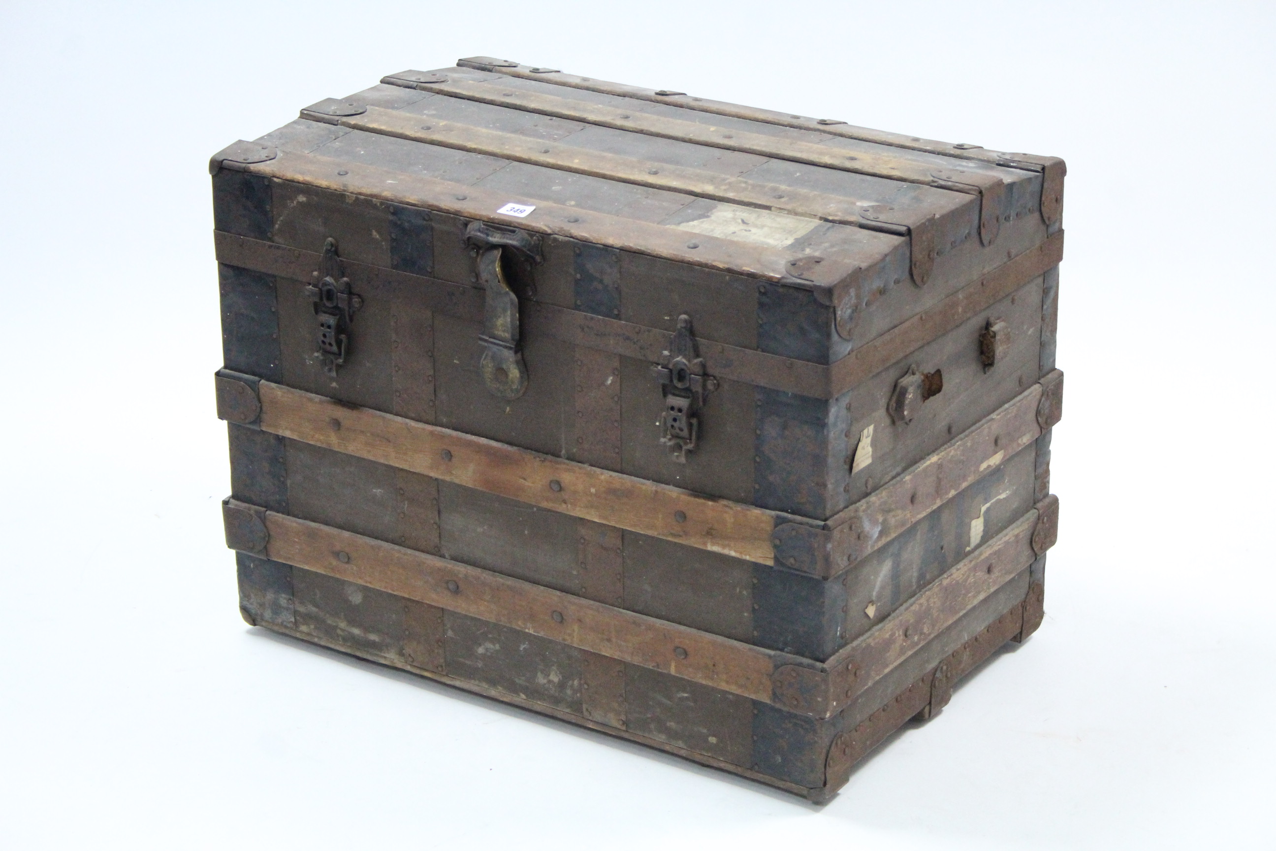 An iron-bound & fibre-covered dome-top travelling trunk with hinged lift-lid (lacking side handles),