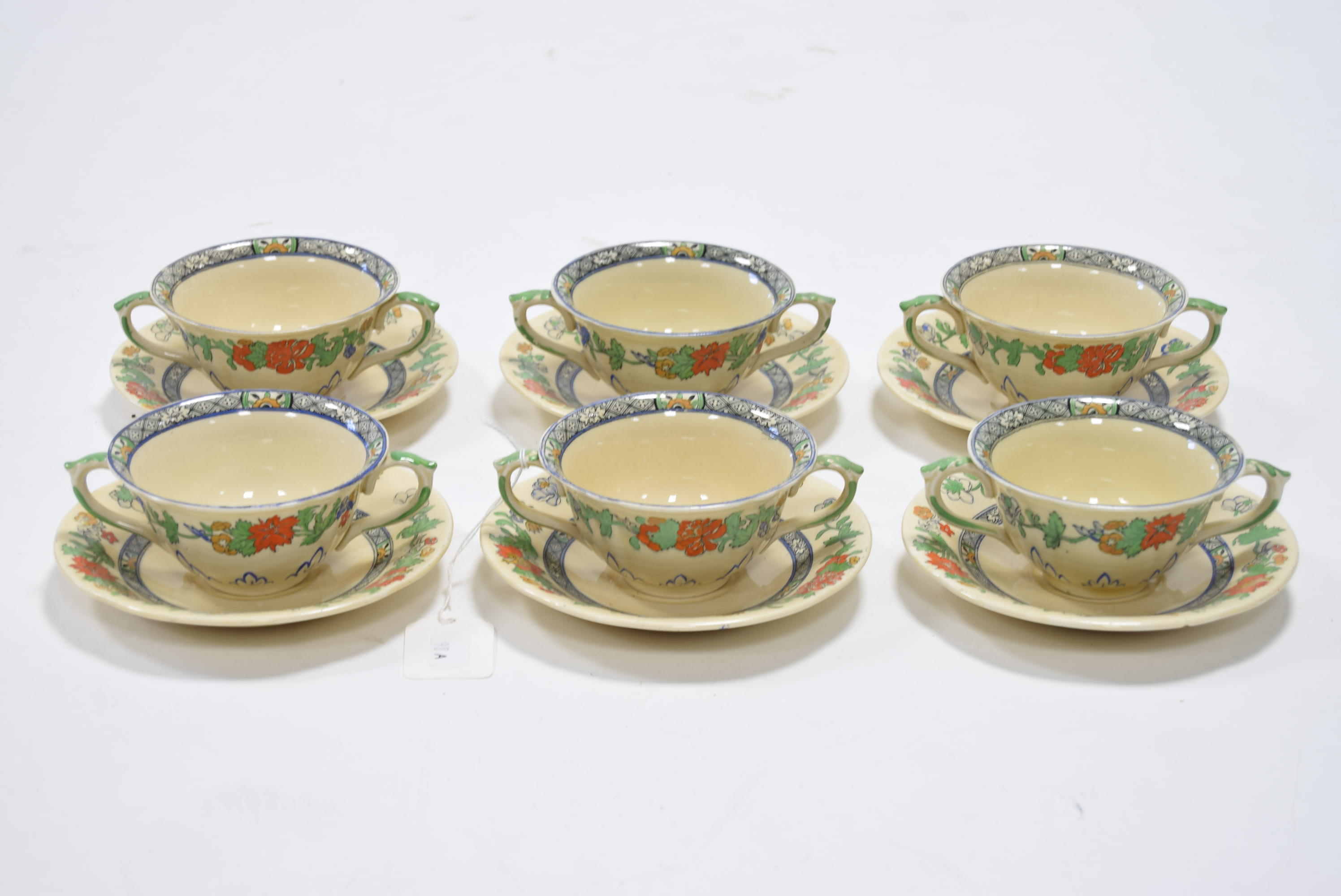 A set of six Mason’s Patent Ironstone China two-handled soup bowls & saucers with floral