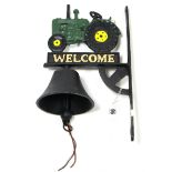 A modern painted cast-iron house bell with tractor surmount, 10" high.