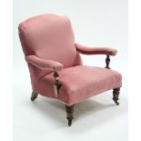 A late Victorian walnut-frame armchair with rounded padded back, sprung seat & padded arms