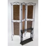 A black painted cast-iron umbrella stand, 23¾” high, w.a.f.; & a black metal frame & woven cane