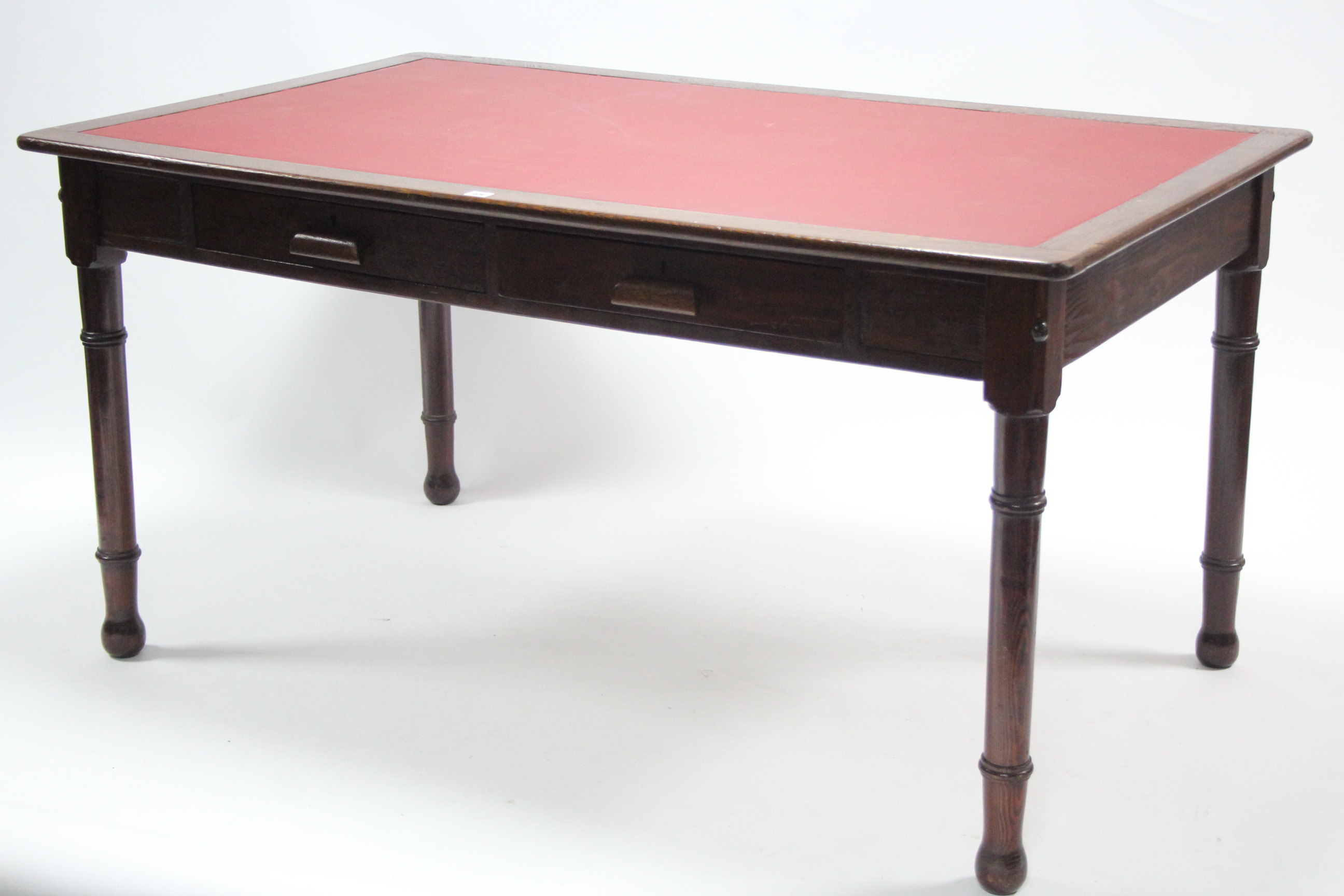 A late 19th/early 20th century oak & pine office table inset crimson leatherette to the