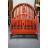 An orange painted 3’ bedstead with pierced & shaped centre splat to the rounded head & footboard,