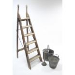 A vintage wooden folding step ladder; together with two galvanised metal buckets & various tools.