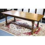 An oak refectory table with rectangular top, & on four baluster-turned legs with plain stretchers,