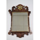 An 18th century style rectangular wall mirror in mahogany fret-carved frame with parcel gilt