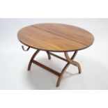 A mahogany coaching table with circular folding top, & on shaped fold-away legs, 39½" diam.